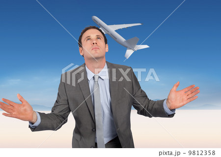 Composite image of businessman posing with hands out Composite image of businessman posing with hands out 9812358
