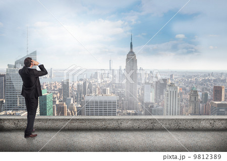 Composite image of stressed businessman with hands on head 9812389