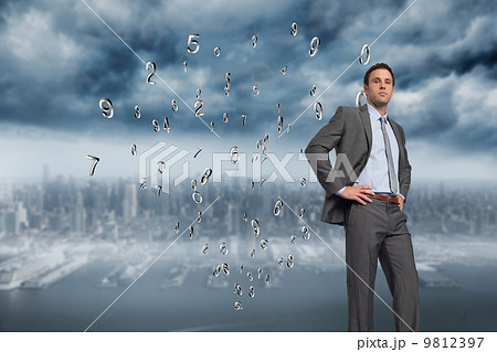 Composite image of serious businessman with hands on hips Composite image of serious businessman with hands on hips 9812397