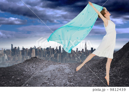 Composite image of young beautiful female dancer with blue scarf Composite image of young beautiful female dancer with blue scarf 9812439