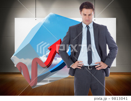 Composite image of serious businessman with hands on hips 9813041