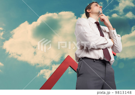 Composite image of thoughtful businessman holding pen to chin Composite image of thoughtful businessman holding pen to chin 9813148