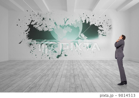 Composite image of thinking businessman with hand on chin 9814513