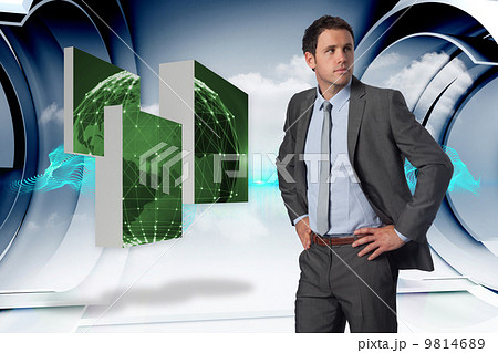 Composite image of serious businessman with hands on hips 9814689