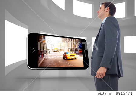 Composite image of stern businessman standing 9815471