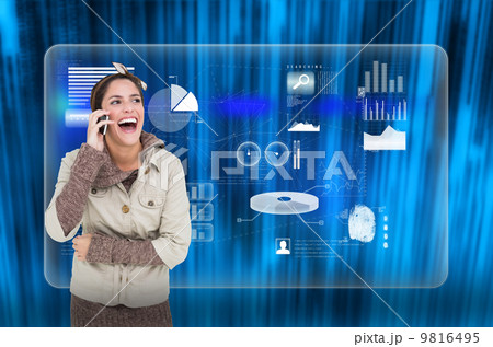 Composite image of laughing cute brunette in winter fashion phon Composite image of laughing cute brunette in winter fashion phon 9816495
