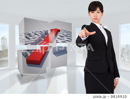 Composite image of focused businesswoman pointing Composite image of focused businesswoman pointing 9816910