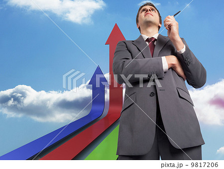 Composite image of thoughtful businessman holding pen Composite image of thoughtful businessman holding pen 9817206