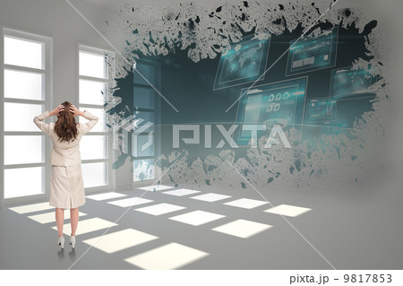 Composite image of businesswoman with hands on head standing bac 9817853