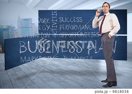 Composite image of thinking businessman holding glasses Composite image of thinking businessman holding glasses 9818038