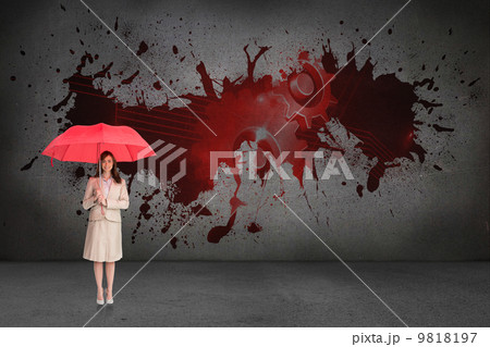 Composite image of attractive businesswoman holding red umbrella Composite image of attractive businesswoman holding red umbrella 9818197