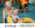 healthy senior woman is enjoying time with her adorable one year old grandchild 9820929