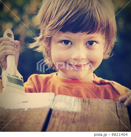 happy boy with paint brush 9821404