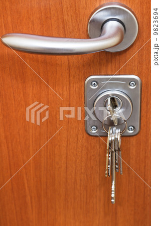 door handle and bunch of keys in keyhole 9823694