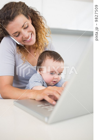 Woman multi tasking at home 9827509
