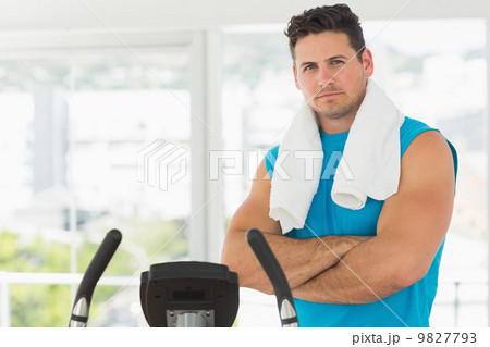 Serious young man working out at spinning class Serious young man working out at spinning class 9827793