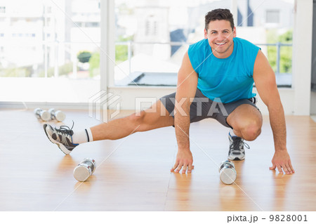Portrait of a sporty man doing stretching exercise Portrait of a sporty man doing stretching exercise 9828001