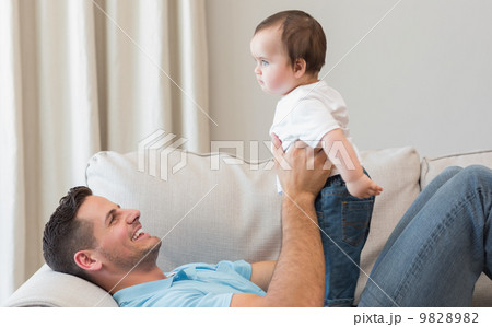 Father playing with baby 9828982