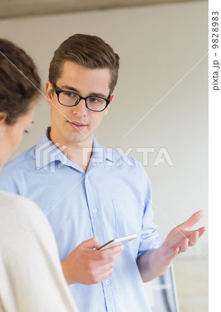 Business people communicating over mobile phone Business people communicating over mobile phone 9828983