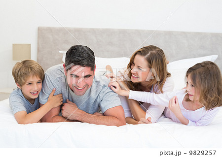Playful family in bed Playful family in bed 9829257