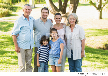 Portrait of a happy extended family in park Portrait of a happy extended family in park 9829313