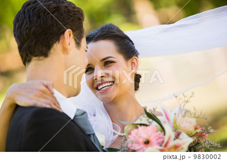 Romantic newlywed looking at each other in park 9830002