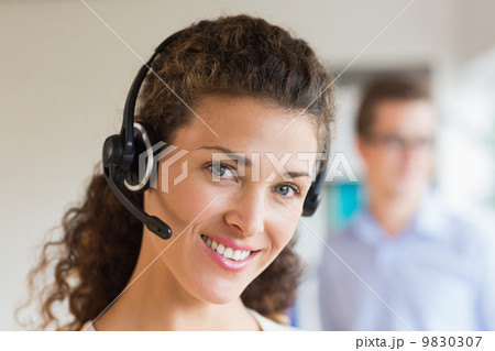 Female call center operator wearing headset 9830307