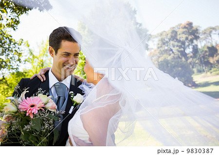 Romantic newlywed looking at each other in park 9830387