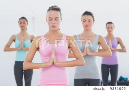 Sporty women with joined hands in fitness studio Sporty women with joined hands in fitness studio 9831096