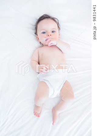 Innocent baby with finger in mouth 9831441