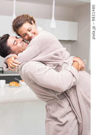 Man lifting and hugging his partner in the morning Man lifting and hugging his partner in the morning 9831480