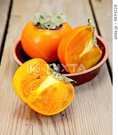 Persimmon on the board in pottery 9834229