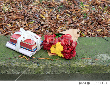 bouquet of chrysanthemums and a stack of books 9837104