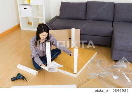 Woman assembling furniture 9843983