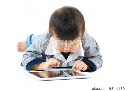 Little baby boy using tablet 9844189