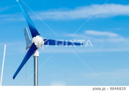 Wind turbine producing alternative energy renewable power on blue sky Wind turbine producing alternative energy renewable power on blue sky 9846820