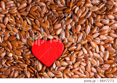 Healthy diet. Flax seeds linseed as food background and red heart 9847273