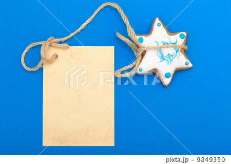 Christmas gingerbread cake star with icing and decoration and blank card 9849350