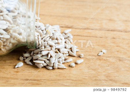 sunflower seeds in glass jar on wooden table background. sunflower seeds in glass jar on wooden table background. 9849792