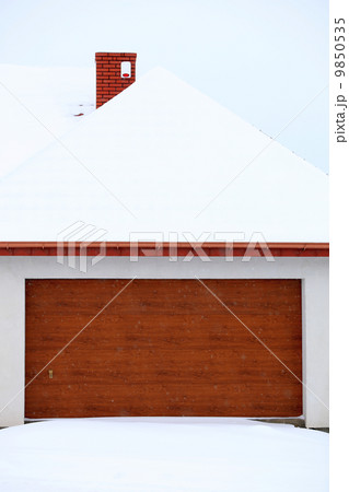 car garage door surrounded by snow 9850535