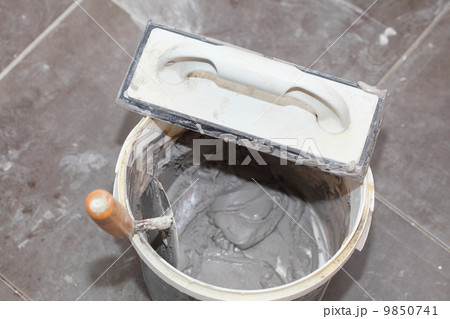 Dirty trowel and bucket on building site. Renovation at home Dirty trowel and bucket on building site. Renovation at home 9850741