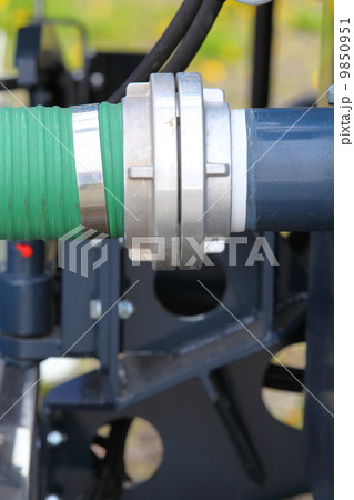 green plastic hose tube is connected to blue steel pipeline green plastic hose tube is connected to blue steel pipeline 9850951