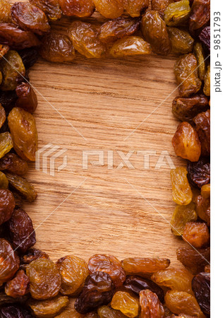 Diet healthy food. Border of raisin on wooden background 9851793