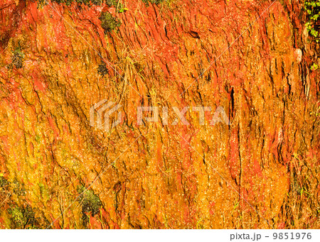 Background of orange wet stone rock wall texture outdoor Background of orange wet stone rock wall texture outdoor 9851976