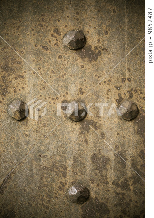 Brown grunge metal plate or armour texture with rivets Brown grunge metal plate or armour texture with rivets 9852487