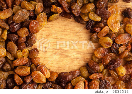 Diet healthy food. Border of raisin on wooden background Diet healthy food. Border of raisin on wooden background 9853512