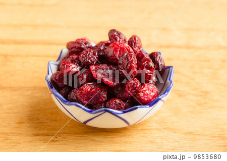 Diet healthy food. Dried cranberries in bowl on wooden table background 9853680