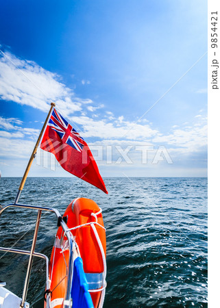 Blue sea. View from deck of yacht sailboat british flag lifebuoy. Travel. 9854421