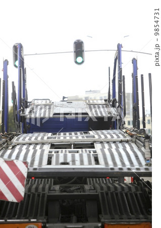 Empty car carrier truck on city road 9854731