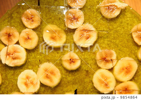 Fruit jelly cake with babana as background Fruit jelly cake with babana as background 9854864